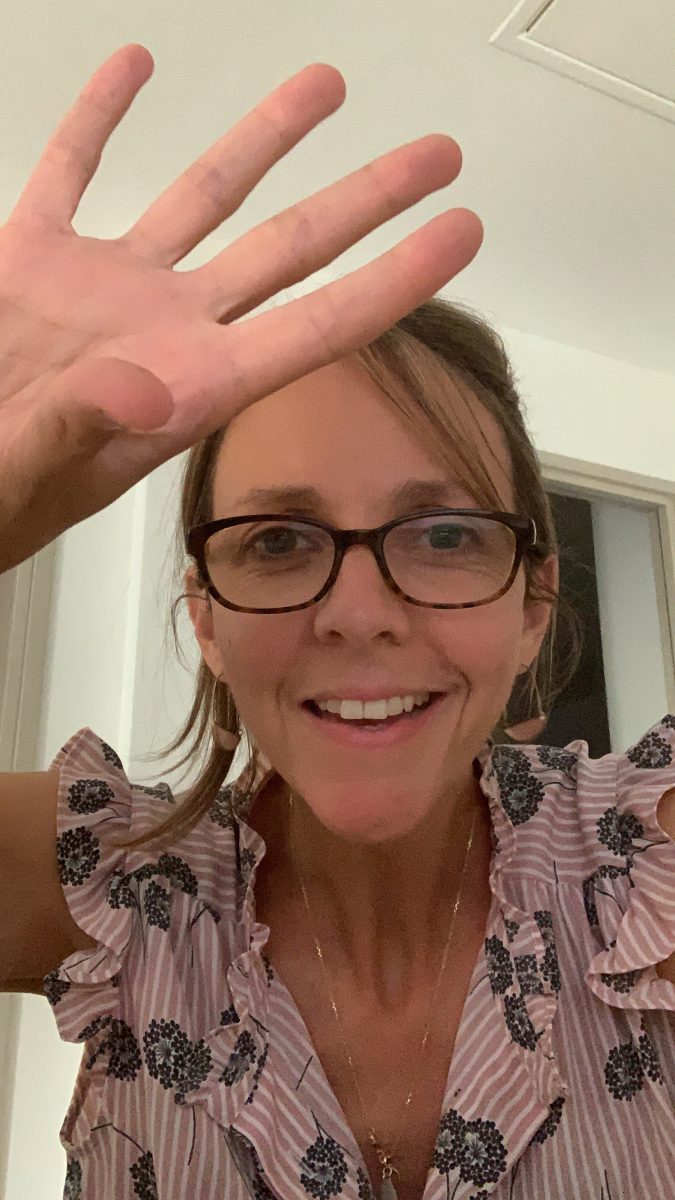 Jeune femme à lunette qui fait un signe de la main